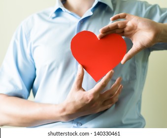 Young Man Holding A Heart In His Hands