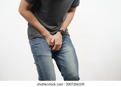 Young man holding his crotch suffering from Diarrhea, incontinence, prostatitis, venereal disease. Healthcare concept.