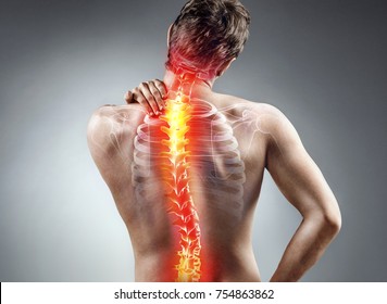 Young Man Holding His Neck In Pain. Medical Concept.