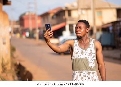 Young Man Holding Up His Phone Like He's Looking For Network Signal