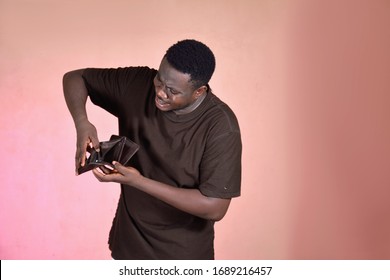 Am Young Man Holding His Wallet, He Is So Frustrated Because There Is No Money