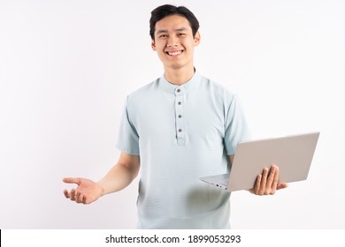 Young Man Holding Laptop On Color Background
