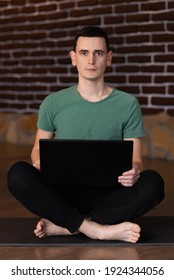 A Young Man Is Holding Laptop Without Smile In The Living Room At Home