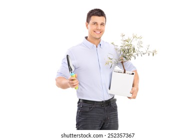 Young Man Holding An Olive Tree Plant And A Spade Isolated On White Background