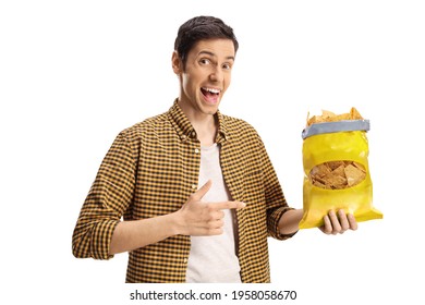 Young man holding a pack of tortilla chips and pointing isolated on white background - Powered by Shutterstock