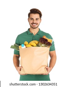 Young Man Holding Paper Bag With Products On White Background. Food Delivery Service