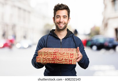 young man holding pizza boxes - Powered by Shutterstock
