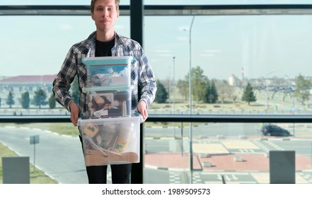 Young Man Holding A Plastic Box Container With Things Stored Inside