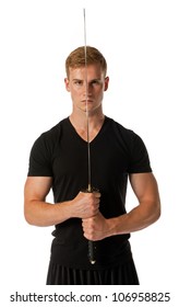 Young man holding a samurai sword isolated on a white background.
