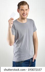 Young Man Holding And Showing Blank Card 