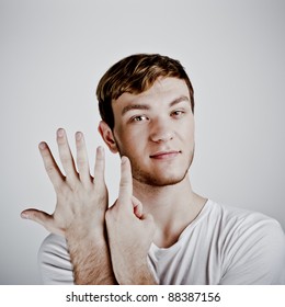 Young  Man Holding Up Six Fingers