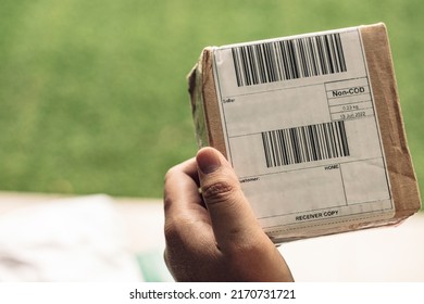 A Young Man Holding Small Delivery Package Box