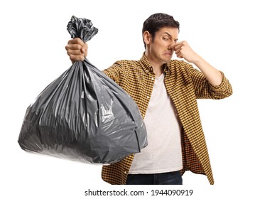 Young Man Holding A Smelly Bin Bag Isolated On White Background