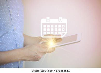 young man holding tablet computer with calendar , social media concept , color filter image , business concept , business idea