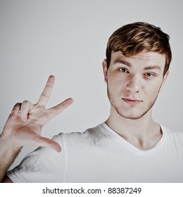 Young  Man Holding Up Three Fingers