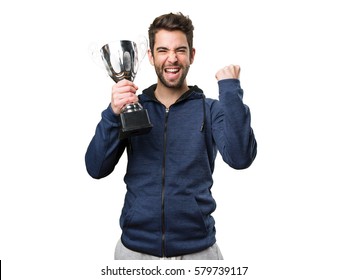 young man holding a trophy and doing winner gesture