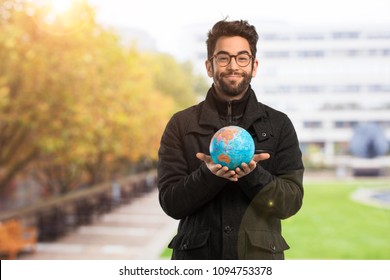 Young Man Holding A World Globe