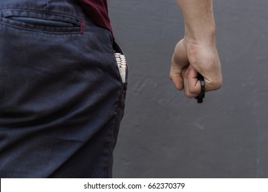 The Young Man Holds The Brass Knuckles