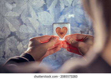 A Young Man Holds A Heart Shaped Object, Conveying A Range Of Emotions Such As Love, Longing, Loneliness And Infatuation.