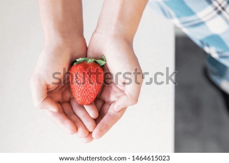 Similar – Woman holds strawberries in her hands