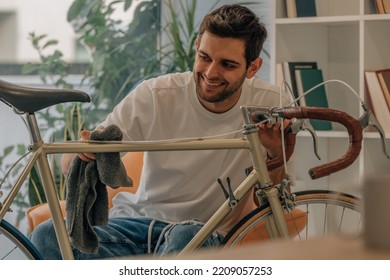 young man at home cleaning vintage retro bike