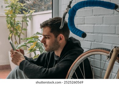 young man at home with mobile phone sitting on the floor - Powered by Shutterstock