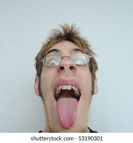 An young man with a huge mouth and tongue sticking out