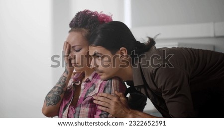 Young man hugging and comforting sad wife in wheelchair. Close up portrait of husband embracing and supporting disabled woman in hospital ward