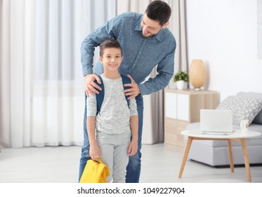 Young Man Hugging His Son Before School