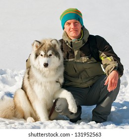 Young Man With Husky Dog