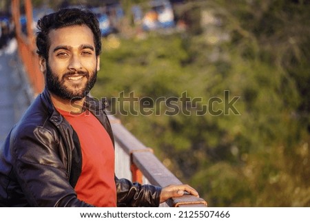 A young man images watching camera