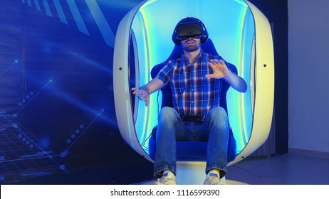Young man immersing in virtual reality experience sitting in a moving chair
