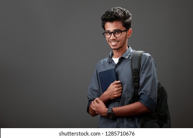 Young man of Indian origin with a book in his hand
