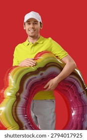 Young man with inflatable ring on red background