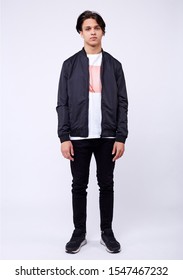 Young Man In Jeans, Black Bomber Jacket On White Background.