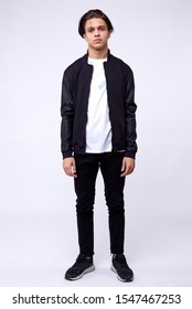 Young Man In Jeans, Black Bomber Jacket On White Background.