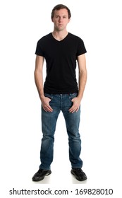 Young Man In Jeans And A Black Tee Shirt. Studio Shot Over White.