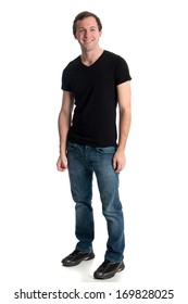 Young Man In Jeans And A Black Tee Shirt. Studio Shot Over White.