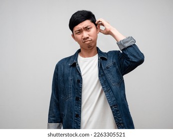 Young man jeans shirt scratch head feels doubt and confused isolated - Powered by Shutterstock