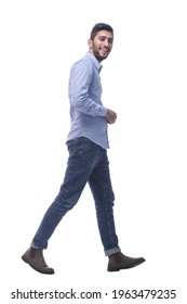 young man in jeans striding confidently forward. - Shutterstock ID 1963479235