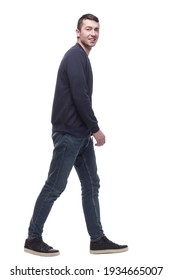 young man in jeans striding forward . isolated on a white - Shutterstock ID 1934665007