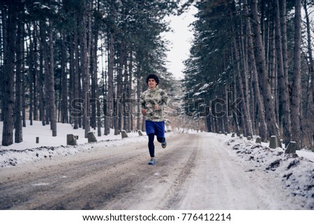 Similar – Young man running outdoors during workout in a forest