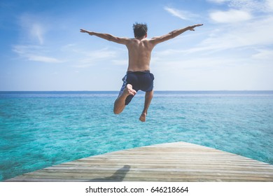 Young Man Jump On The Sea