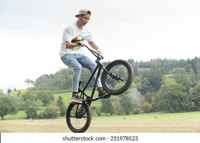 Young man jumping with bike over ramp - Powered by Shutterstock