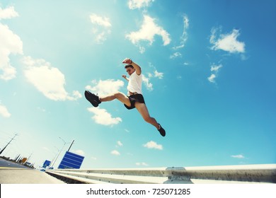 Young man jumping - fitness, sport, parkour and people concept 