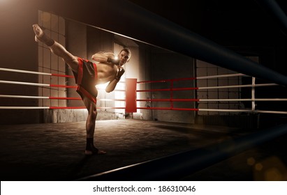 Young  man kickboxing in the Arena