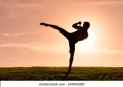 Young Man Kickboxing Outdoors