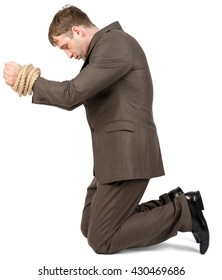 Young Man Kneeling With Bound Hands Isolated On White Background