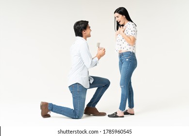 Young Man Kneeling In Front Of Girlfriend And Proposing Her With Ring