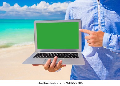 Young Man With Laptop During Beach Vacation